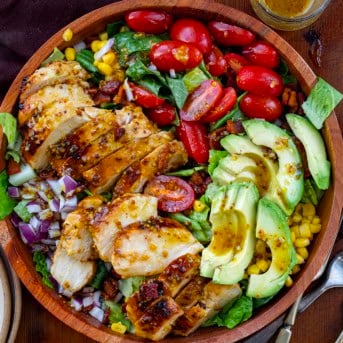 Bowl of Avocado Chicken Salad on a wooden table from overhead.