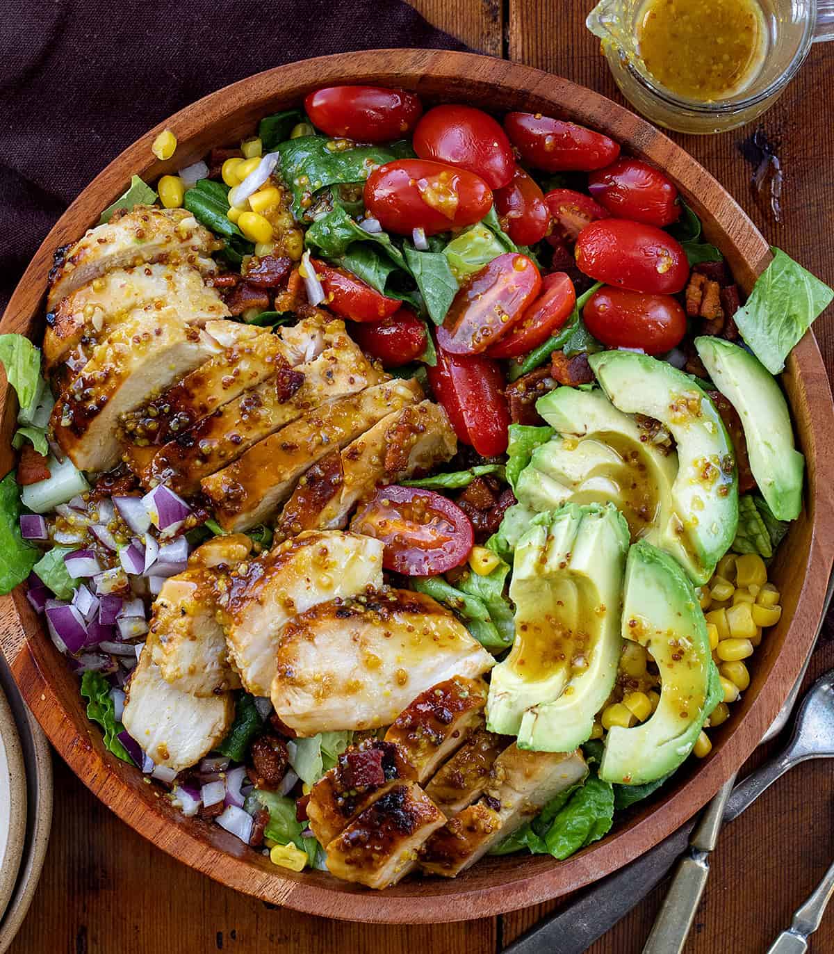 Bowl of Avocado Chicken Salad on a wooden table from overhead.