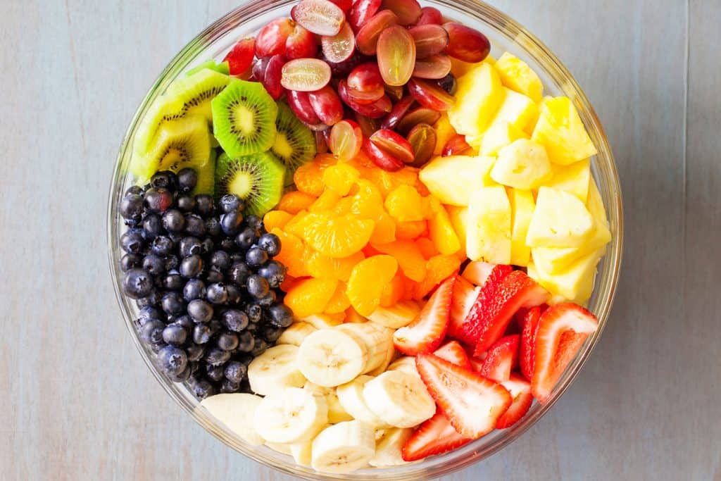 Rainbow Fruit Salad with Honey Lime Dressing from iamhomesteader.com