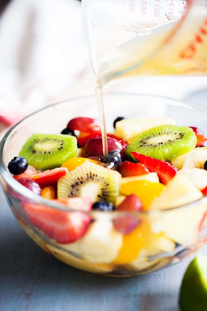 Rainbow Fruit Salad with Honey Lime Dressing from iamhomesteader.com