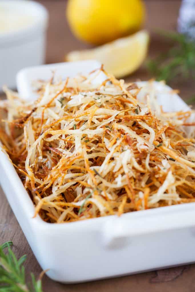 Baked Parmesan Rosemary Shoestring Fries are the perfect side dish! #hashbrowns #frenchfries #shoestringfries #potato #lemondippingsauce #iamhomesteader Baked Parmesan Rosemary Shoestring Fries are the perfect side dish!