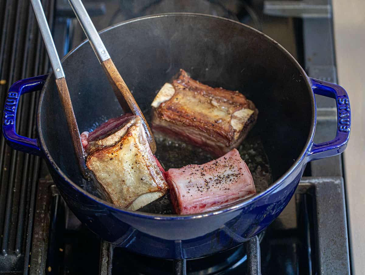 Searing Beef Short Ribs in a pot.