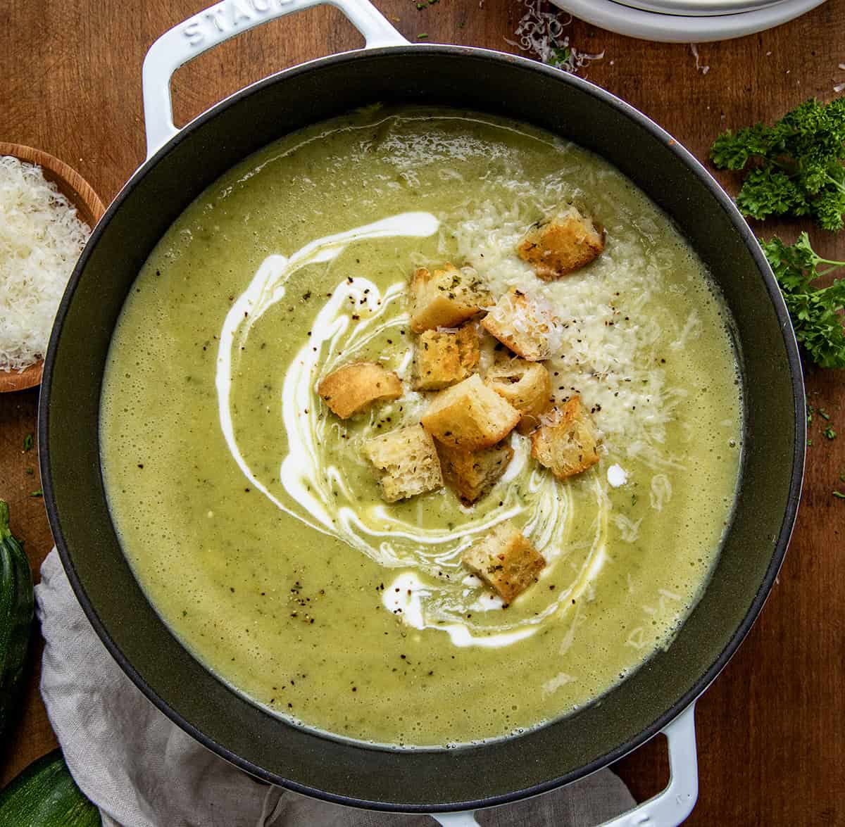 Pot of Zucchini Soup on a wooden table from overhead.