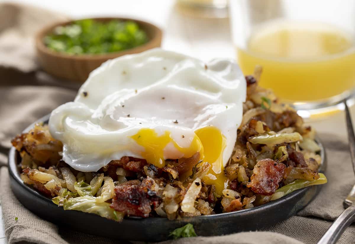 Brussels Sprouts Breakfast Hash on a Plate with Cut Into Egg. Breakfast, Hash, How to Make Hash, Poached Egg, How to Poach and Egg, breakfast recipes, i am homesteader, iamhomesteader.