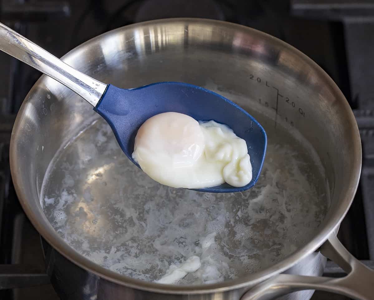 Spoon Holding a Poached Egg for Brussels Sprout Breakfast Hash. Breakfast, Hash, How to Make Hash, Poached Egg, How to Poach and Egg, breakfast recipes, i am homesteader, iamhomesteader.