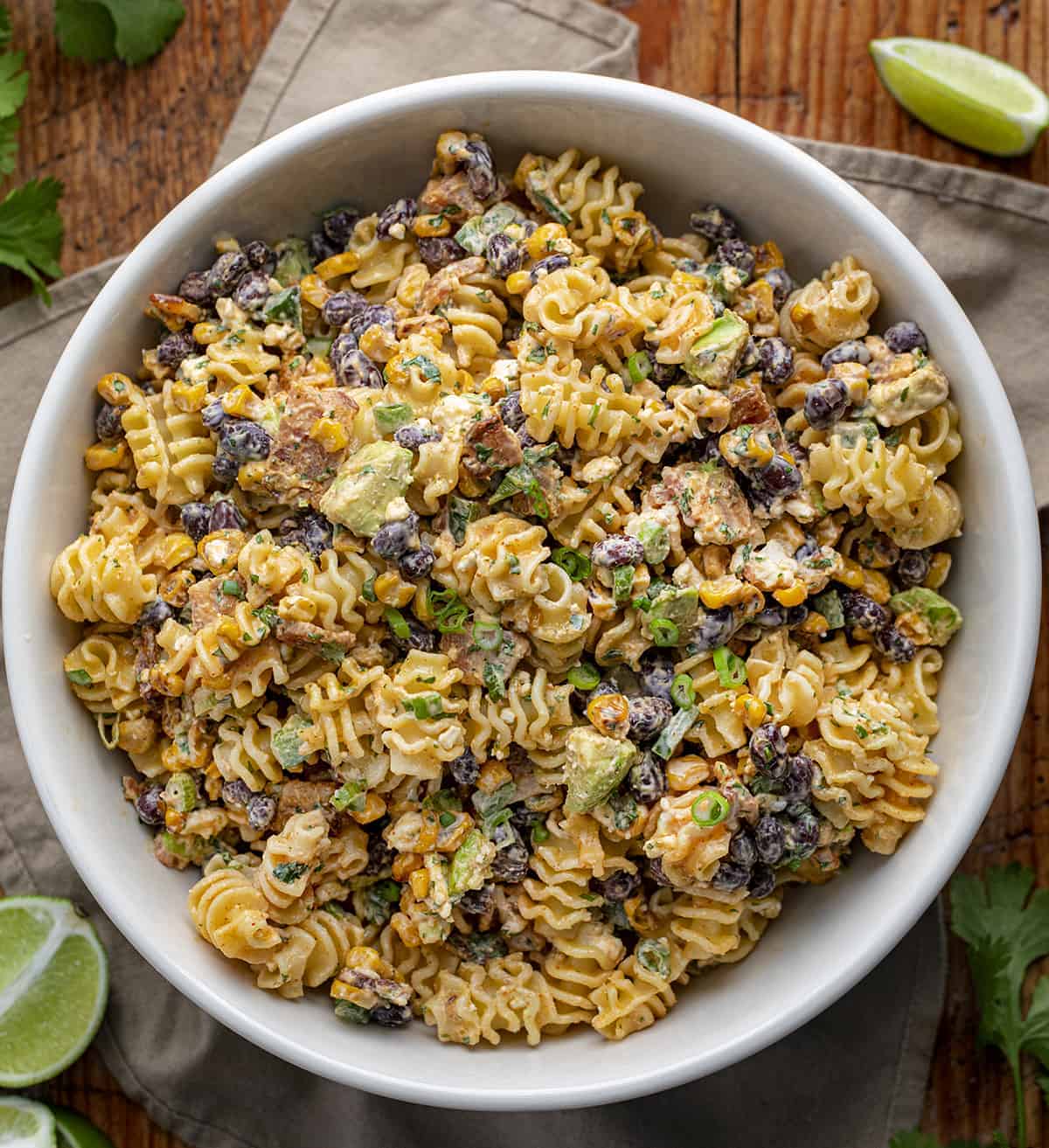 Bowl of Corn Pasta Salad from Overhead on a Cutting Board