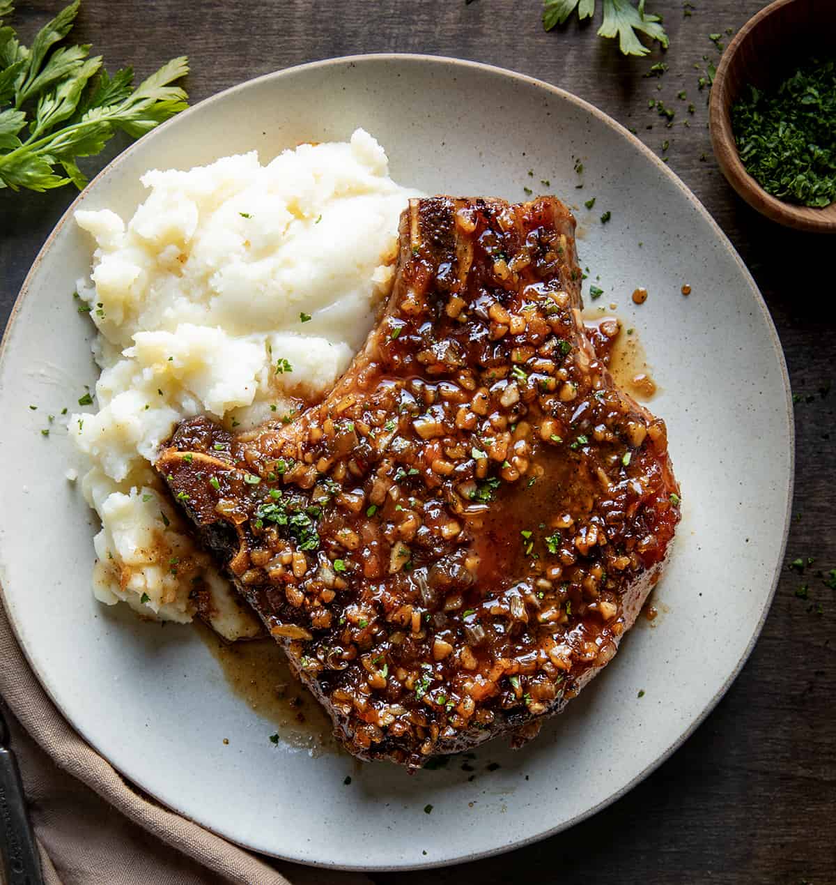 One Honey Garlic Pork Chop on a plate with mashed potatoes.