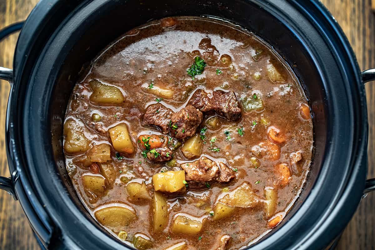 Beef Stew in a Crockpot on a Cutting Board.