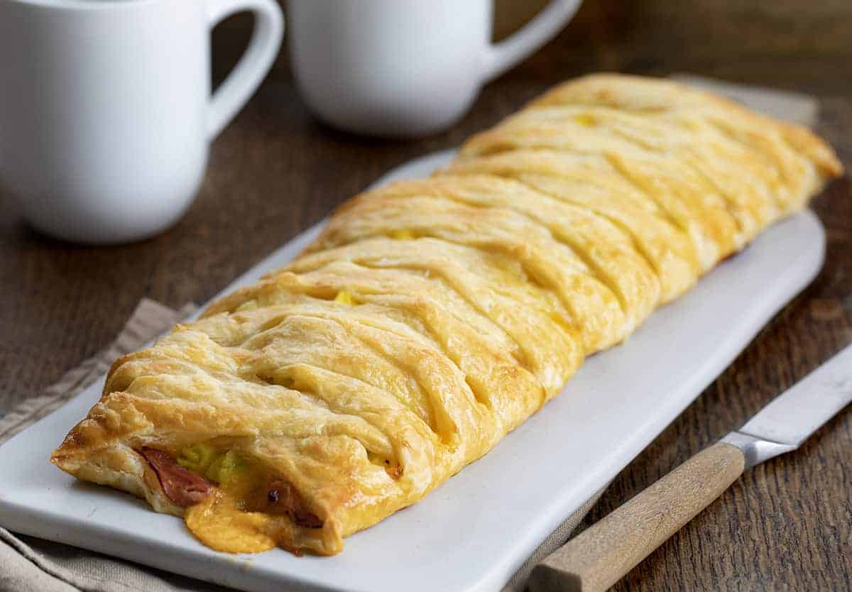 Whole Ham & Cheese Breakfast Puff Pastry on Cutting Board with Knife