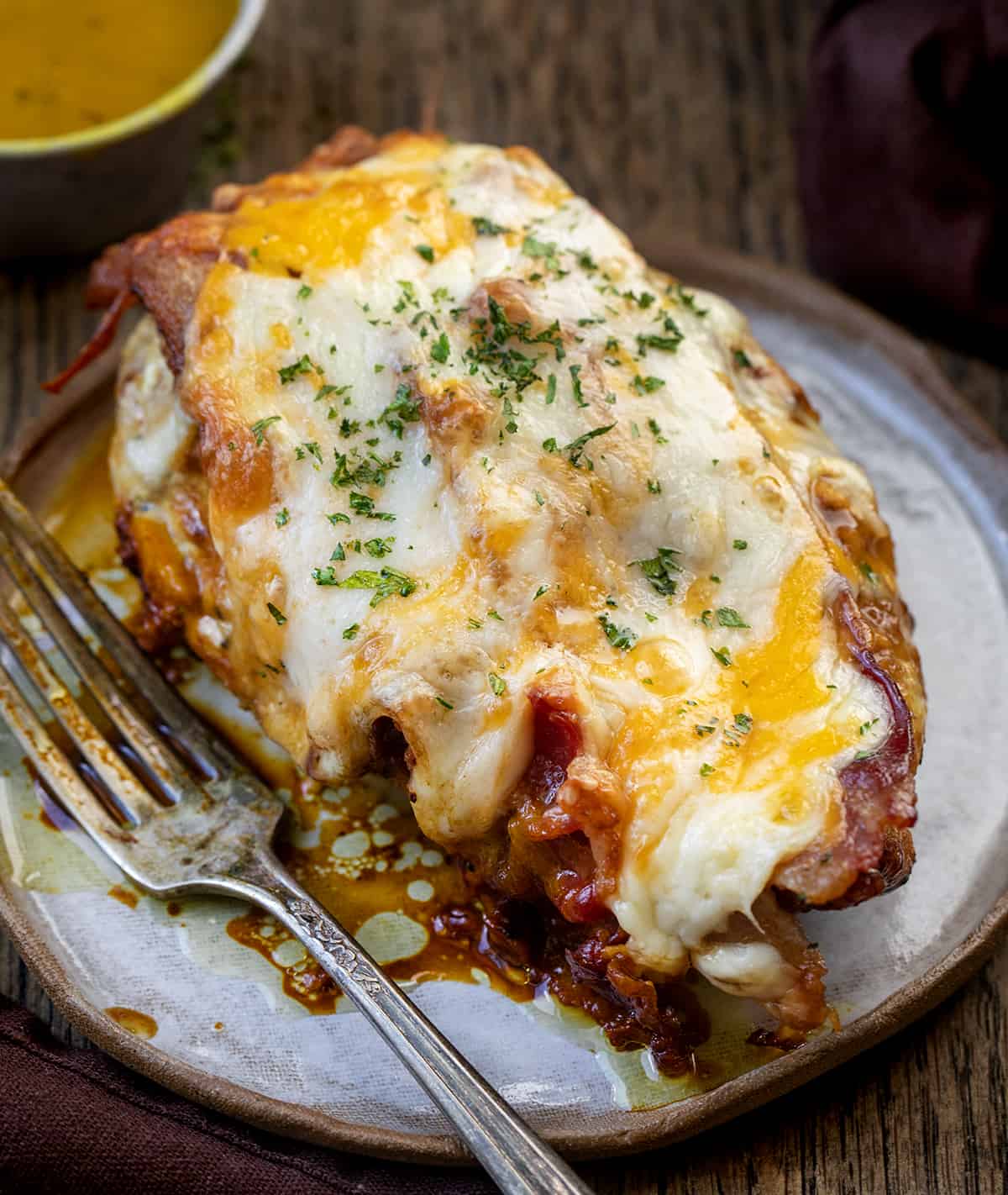 Cheesy Bacon Chicken with Mustard Sauce on a Plate with a Fork.