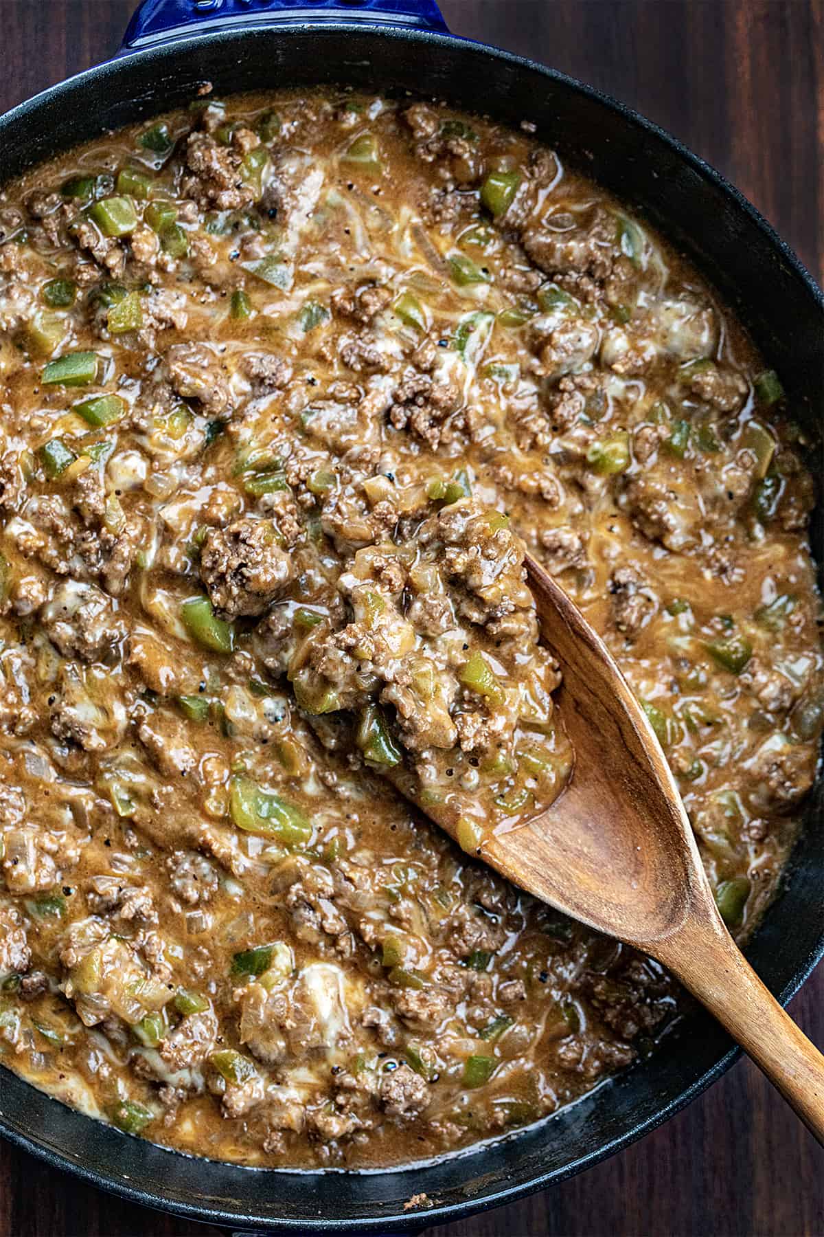 Pan with Meat for Philly Cheesesteak Sloppy Joe's in It on a Spoon.