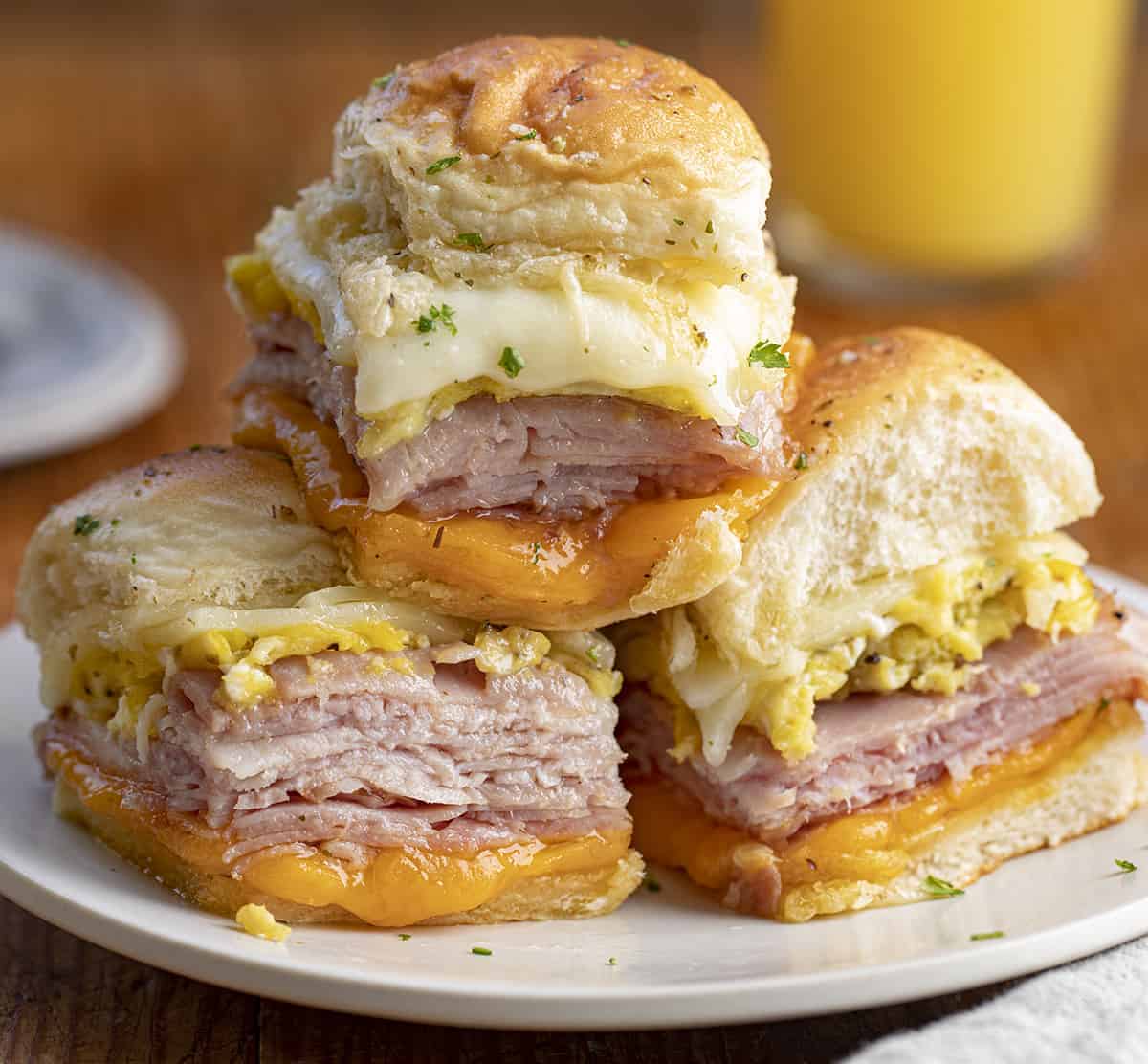 Breakfast Sliders with Ham, Cheese, and Scrambled Egg Stacked on a Plate