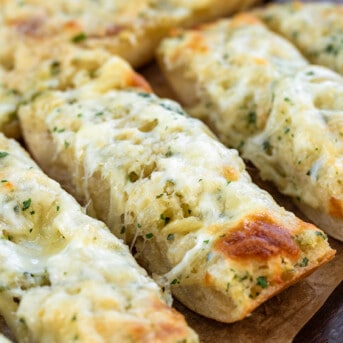 Close up of really cheesy Garlic Cheese Bread cut into slices.