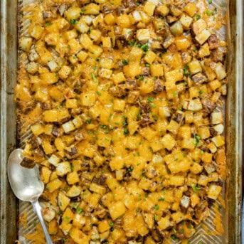 Pan of Cheesy Roasted Potatoes with a serving spoon from overhead.