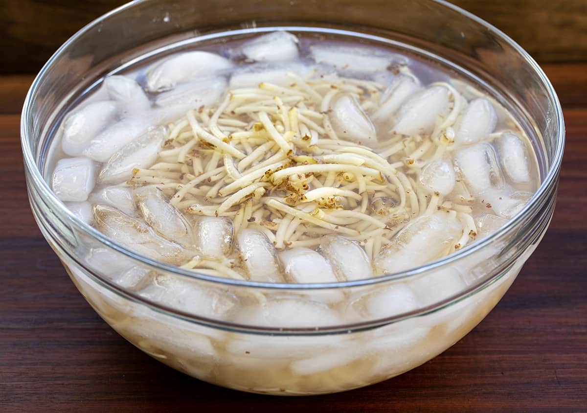 Bowl of Potato shoestrings in Ice Water.