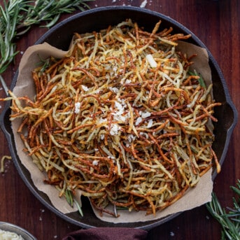 Skillet Filled With Baked Parmesan Rosemary Shoestring Fries.