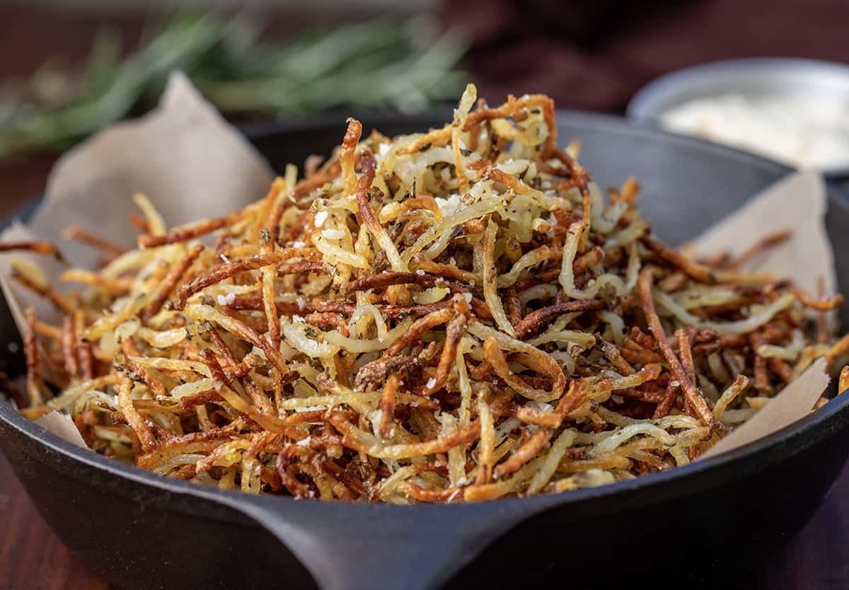 Skillet Filled with Baked Parmesan Rosemary Shoestring Fries.
