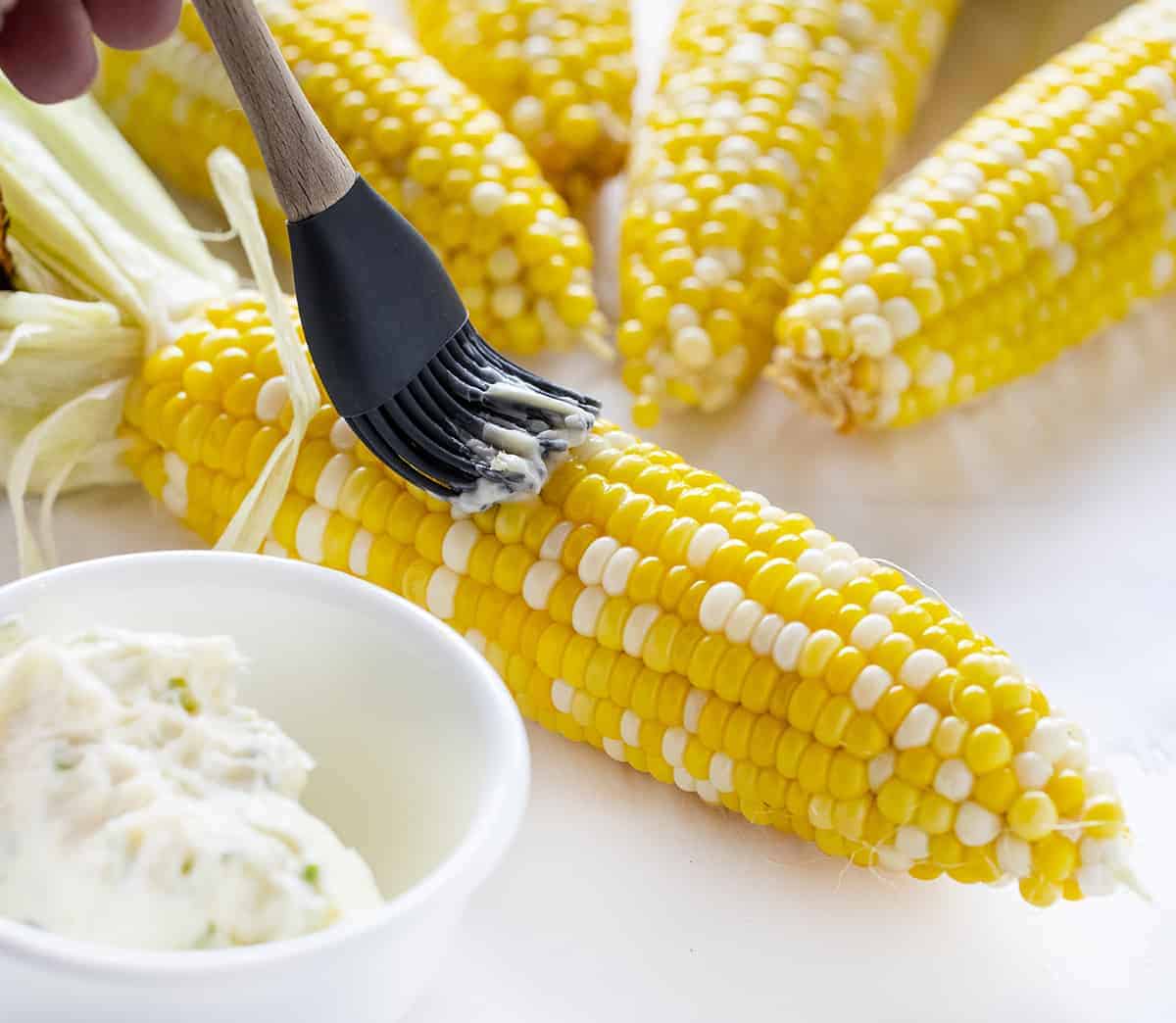 Spreading Herb Butter on Grilled Corn