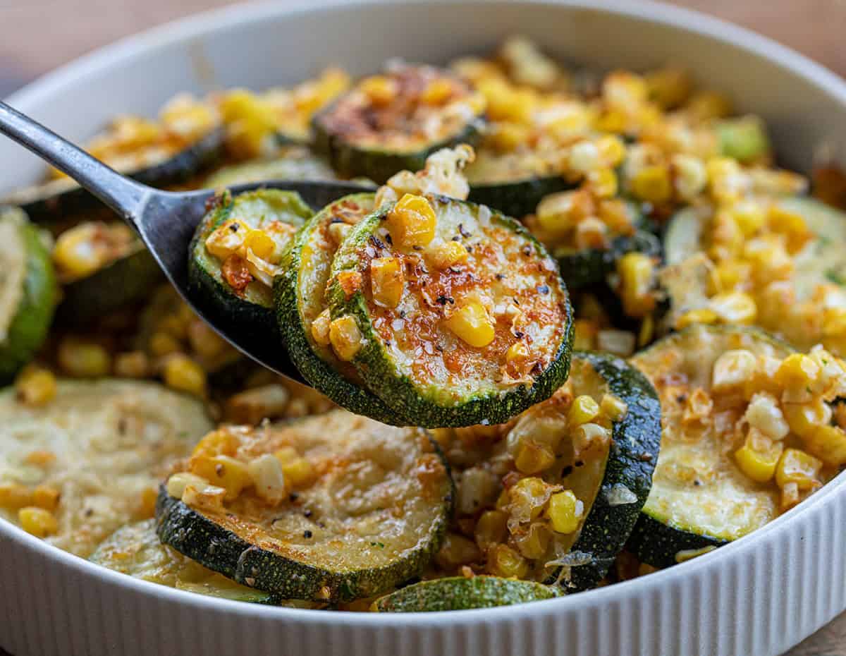 Spoon holding Roasted Zucchini and Corn.