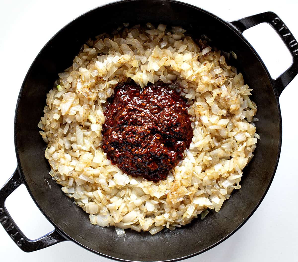 Adding Chipotle Peppers Adobo to Onions for Texas Chili - Bowl of Red