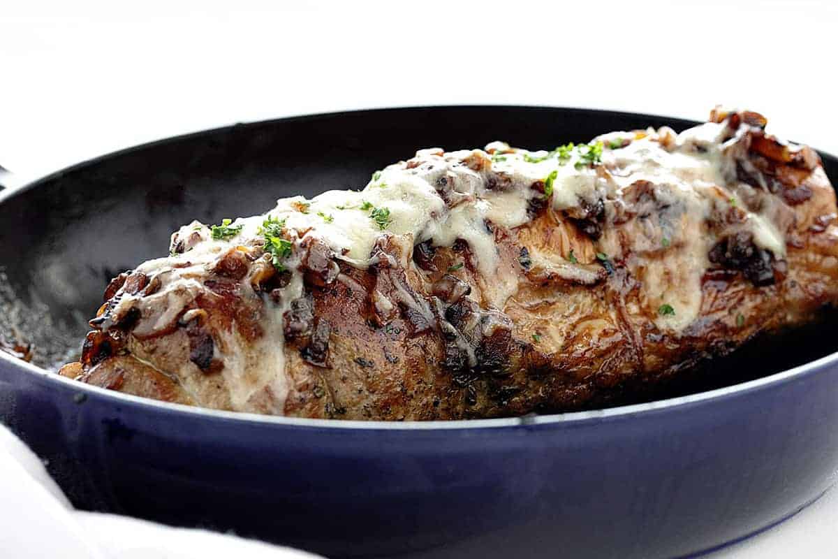 Whole French Onion Stuffed Pork Loin in a Skillet