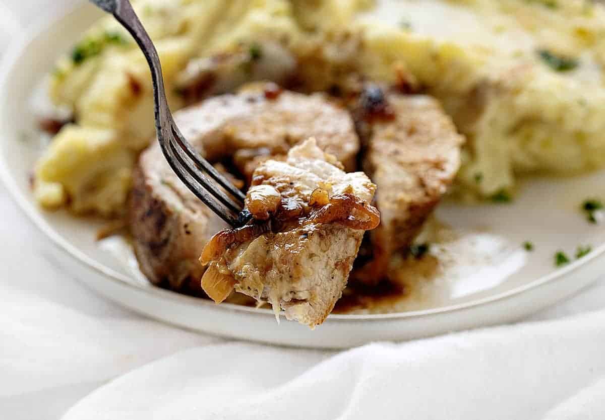 One bite of French Onion Stuffed Pork Loin on a Fork