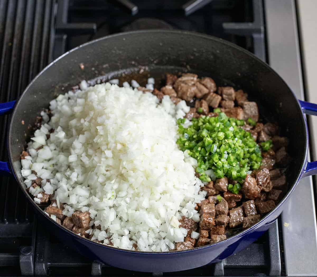 Ingredients for Spicy Steak Chili in a pan on the stovetop.