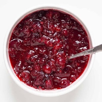 Overhead of a bowl of homeamde cranberry sauce with a spoon