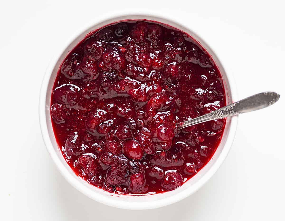 Overhead of a bowl of homeamde cranberry sauce with a spoon