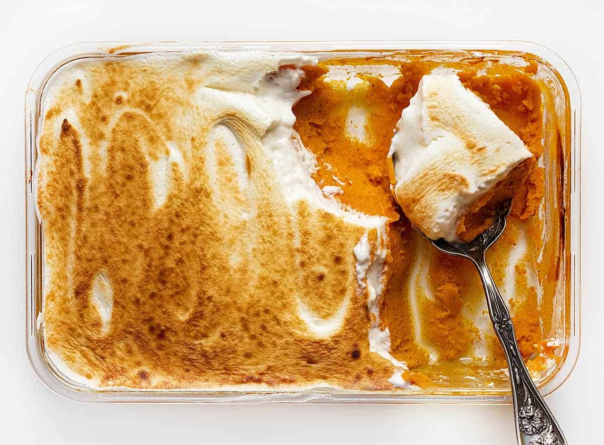 overhead of sweet potato casserole with a spoonful being taken out