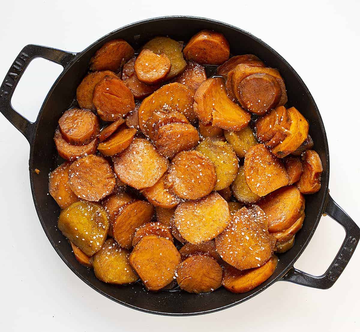 Overhead of Candied Yams in a Skillet and Sprinkled with Salt. 