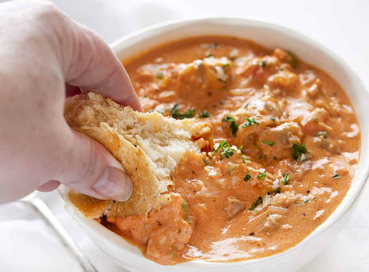 Dipping Bread into Sausage Soup 