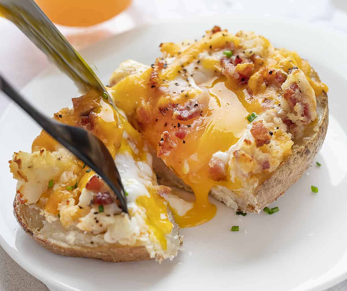 Fork and Knife Cutting into Breakfast Twice Baked Potato