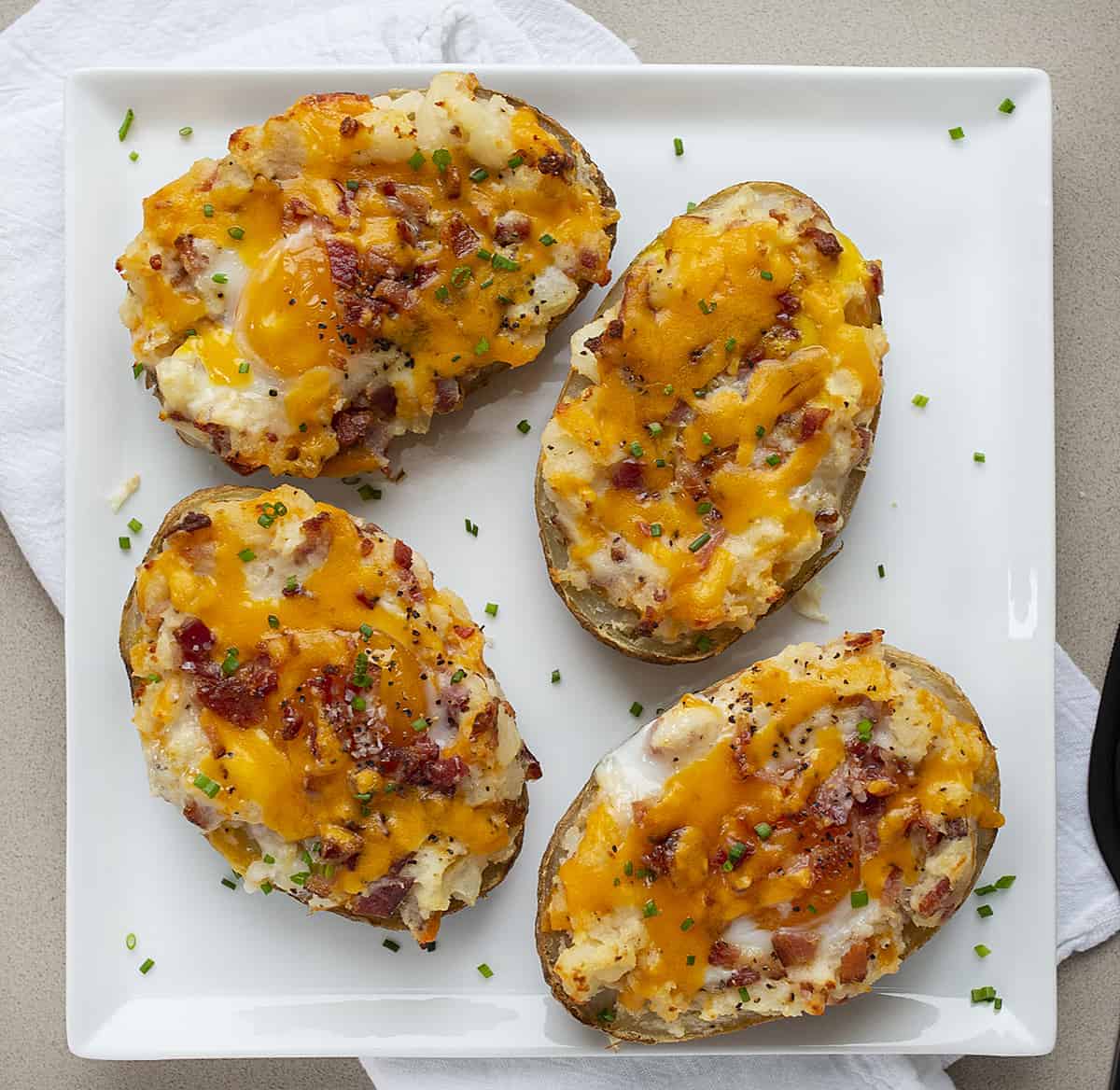 Breakfast Twice Baked Potatoes on a White Plate from Overhead