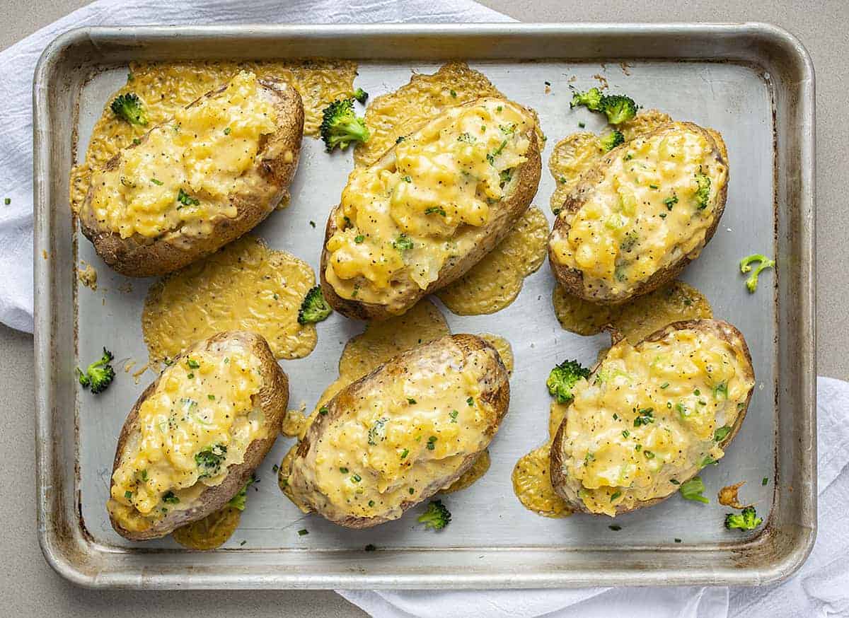 Overhead Pan of Broccoli Cheese Twice Baked Potatoes with Cheese Melting Everywhere
