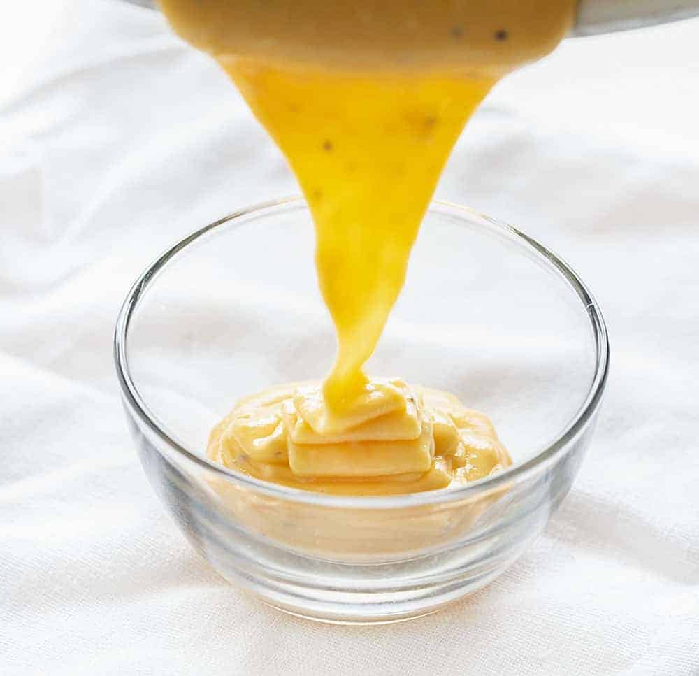 Pouring Cheddar Cheese Sauce into Bowl