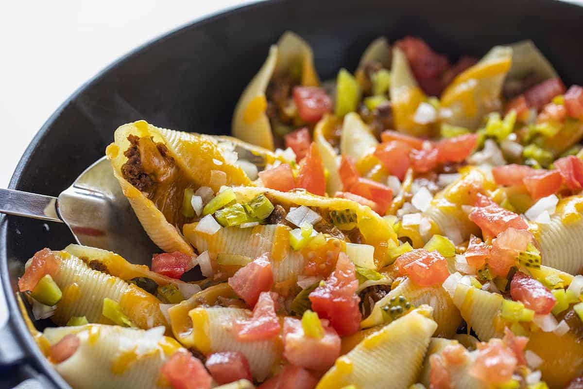 Spoonful of Cheeseburger Stuffed Shells Hot in a Skillet