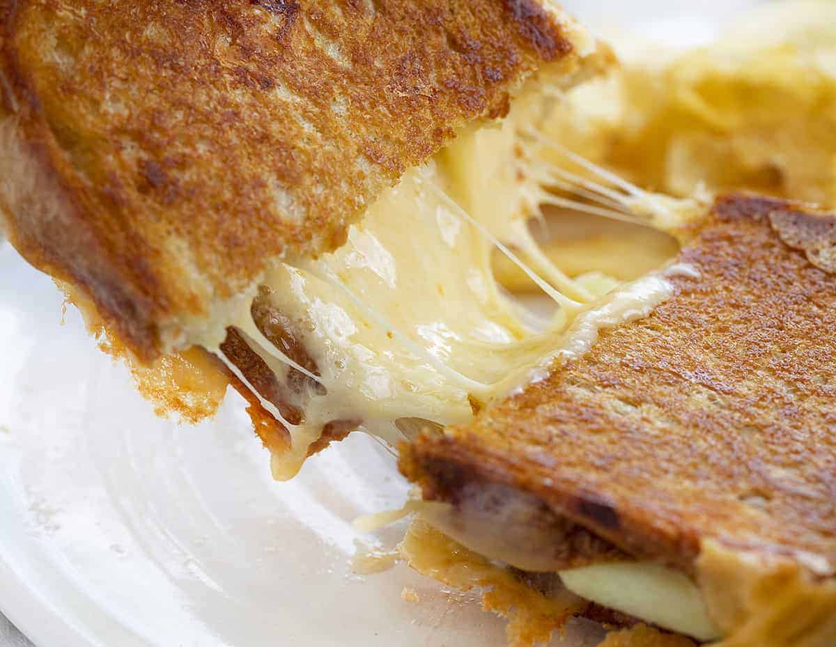 Apple Gouda Grilled Cheese Being Pulled Apart with Gooey Cheese
