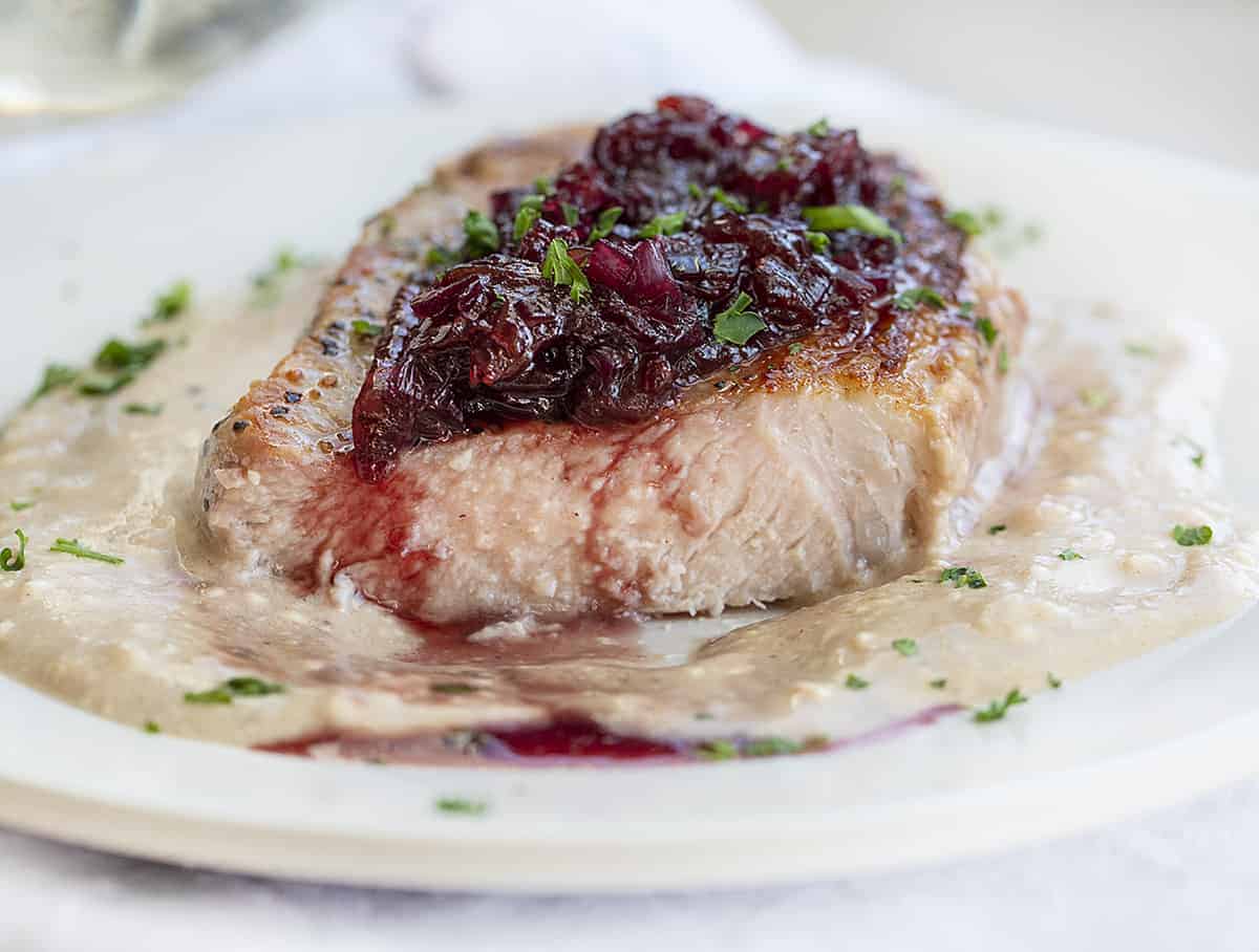 Cut into Cherry Pork Chops on a Plate with Sauces