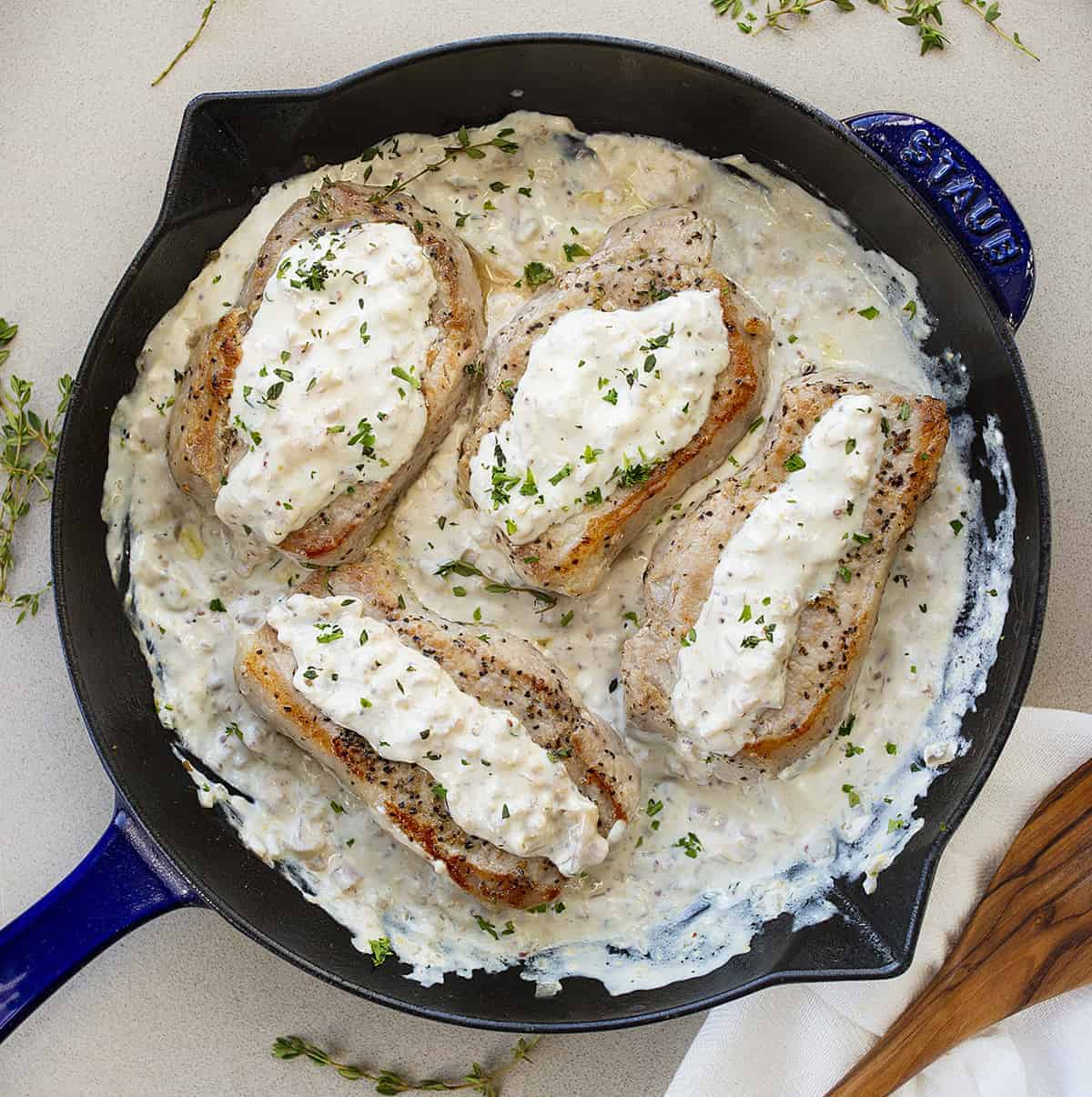 Overhead of Cream Cheese Pork Chops in Blue Skillet