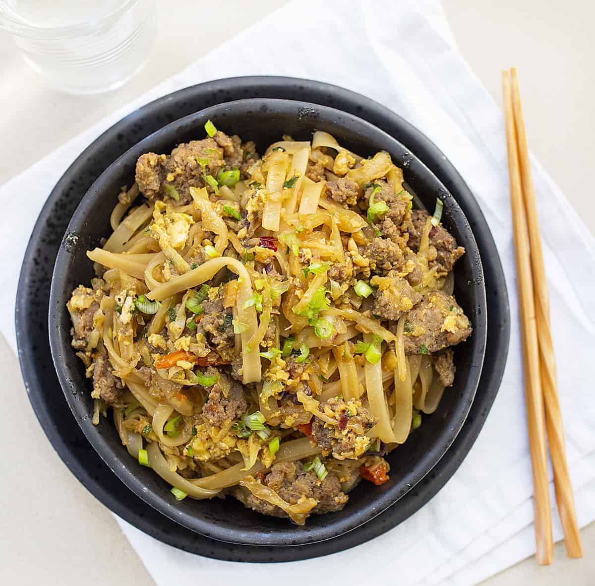 Overhead of Potsticker Noodle Bowl Recipe in Black Bowl with Chopsticks