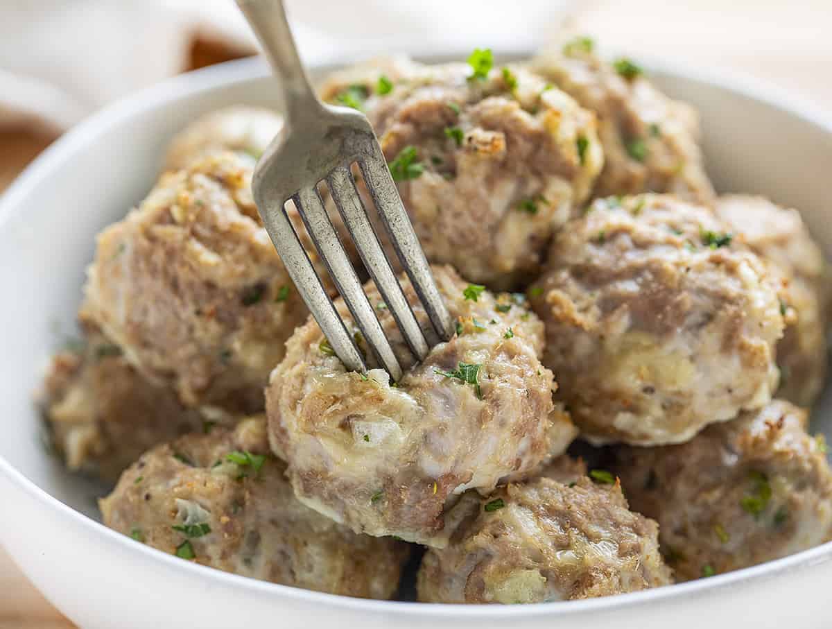 Turkey Meatballs in a Bowl with Fork Picking One Up