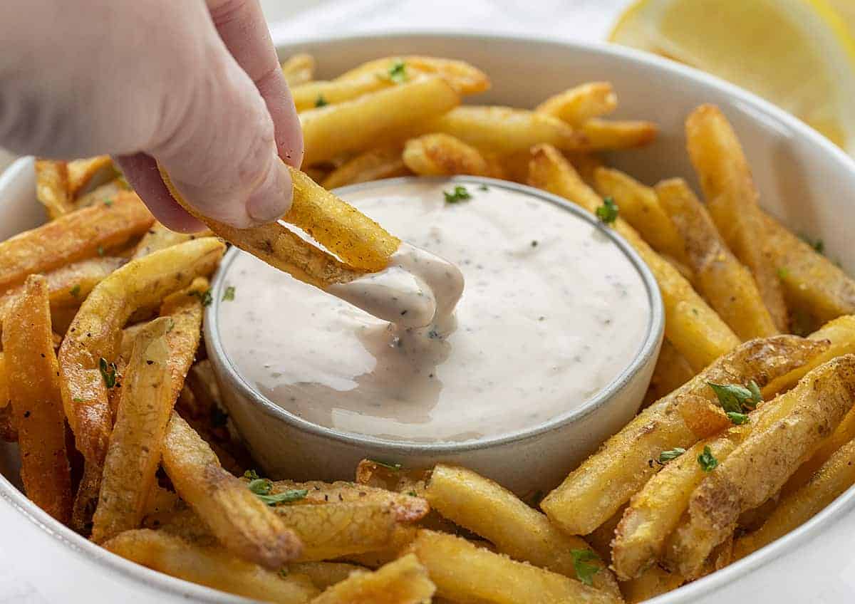 Dipping French Fries into Aioli 