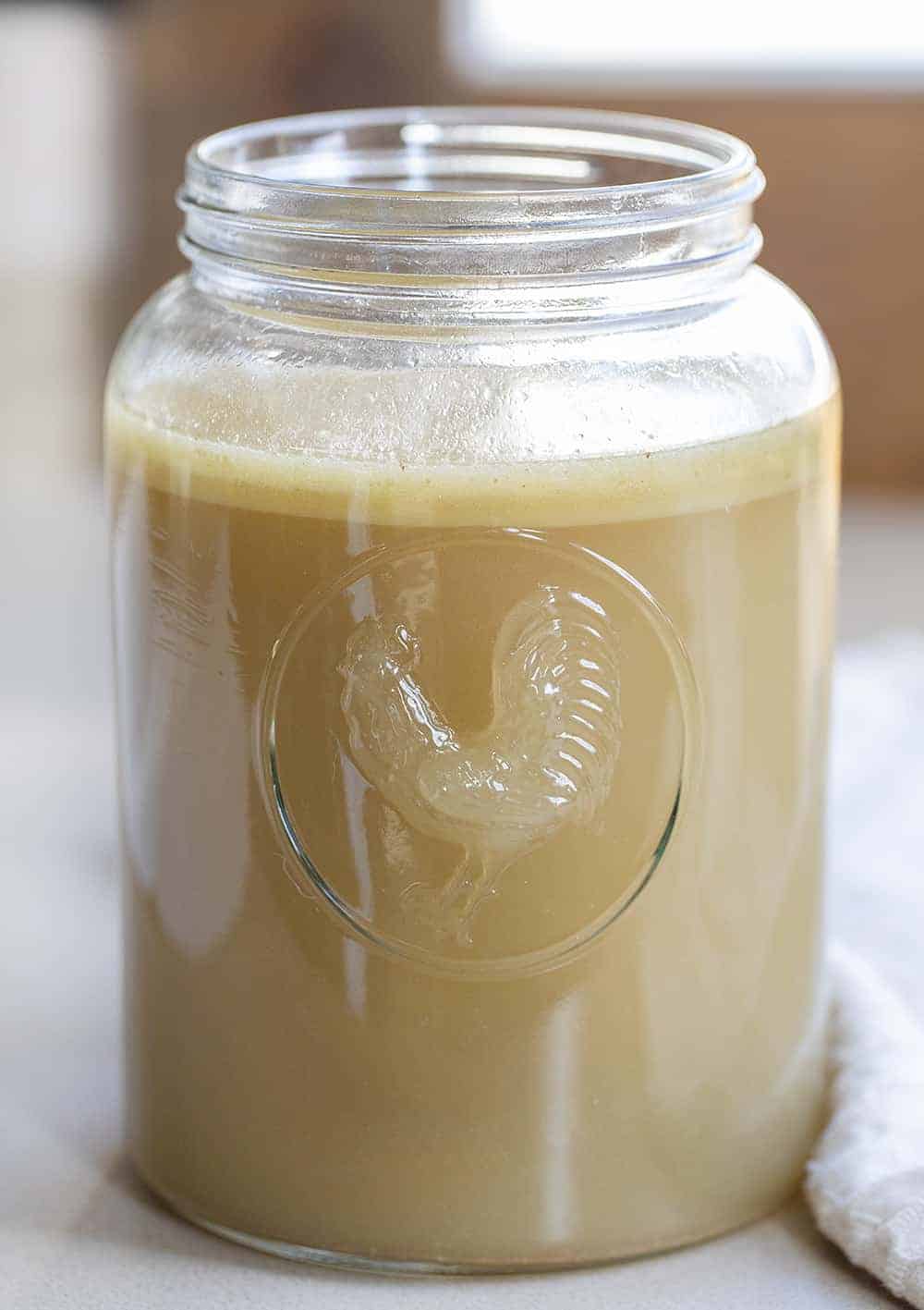 Homemade Chicken Stock in Glass Jar with Chicken on It