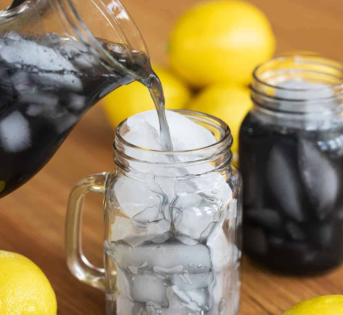 Pouring Charcoal Lemonade into Glass