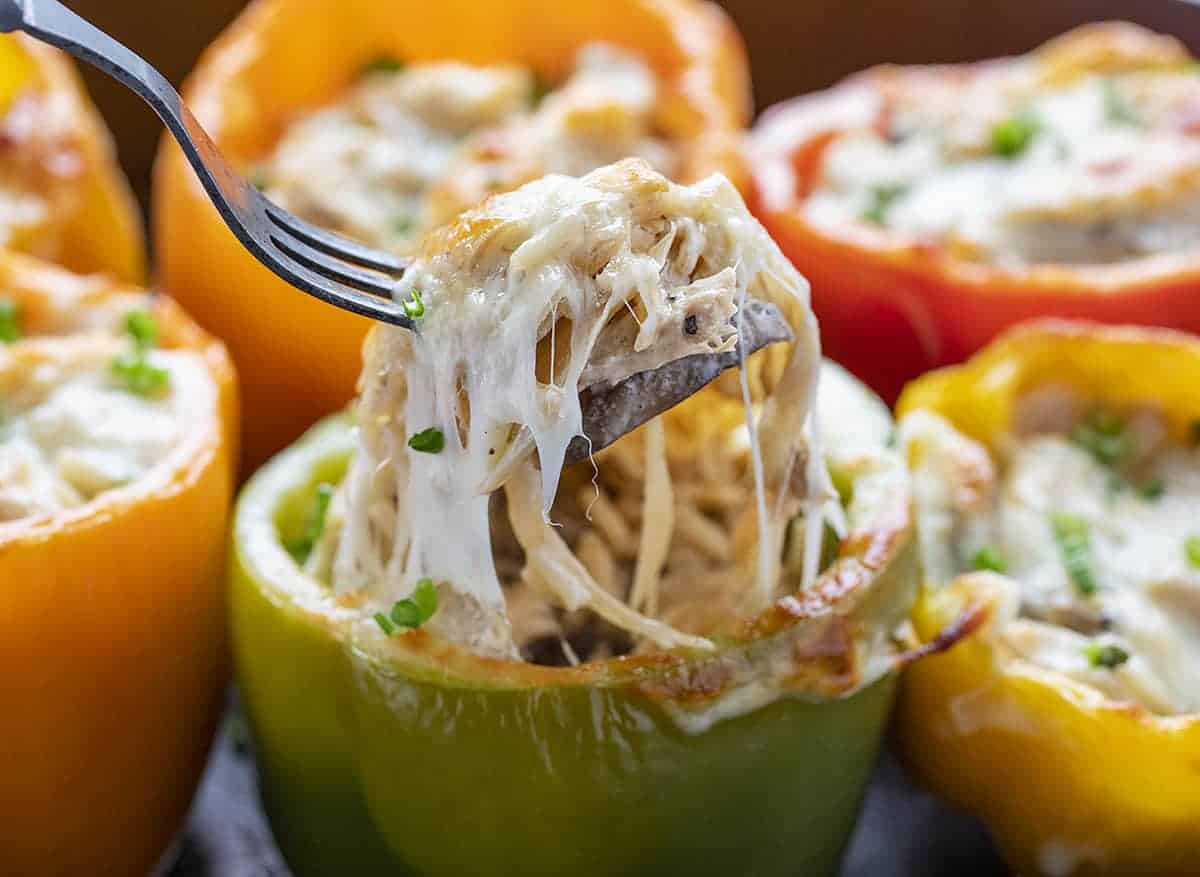 Fork Lifting Up Cheesy Chicken Mushroom Stuffed Peppers