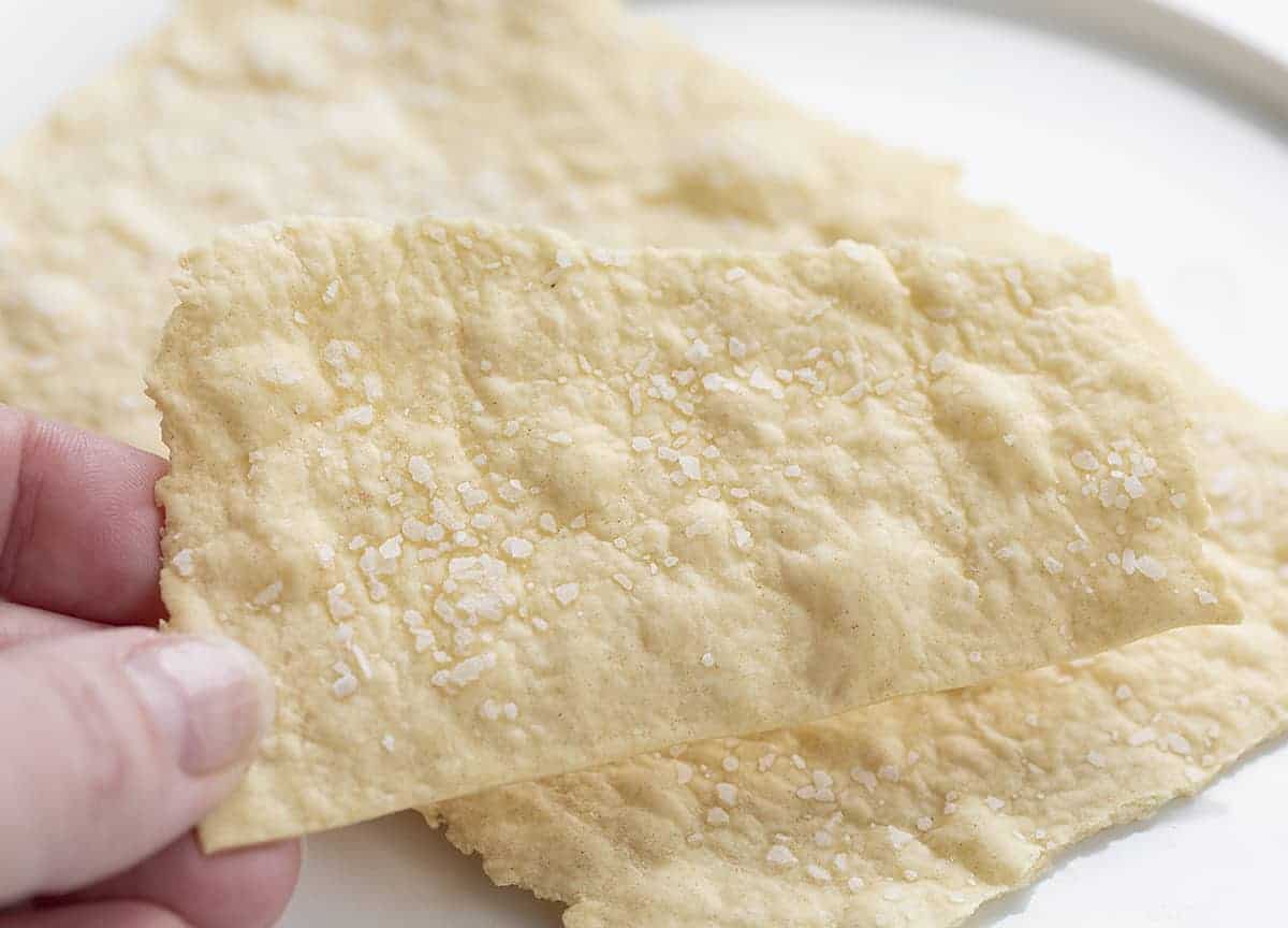 Hand holding one Sourdough Cracker