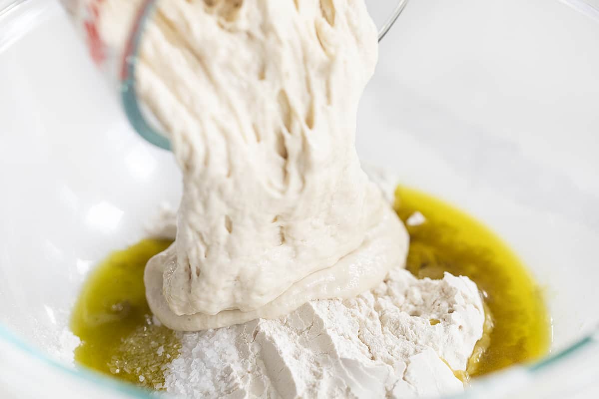 Pouring Sourdough Starter into Sourdough Cracker Ingredients Bowl