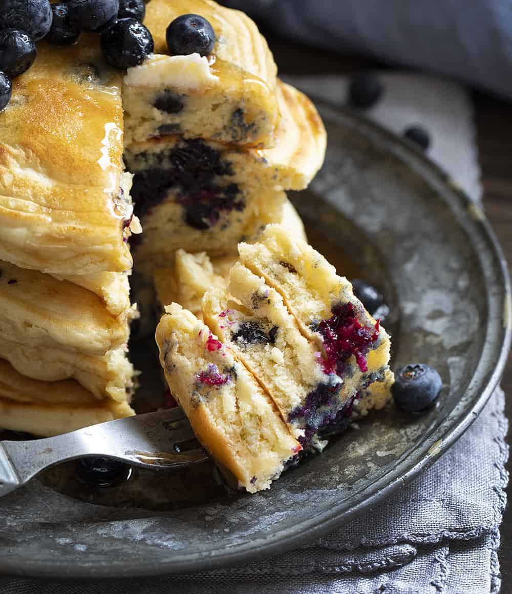 Stacked Blueberry Sourdough Pancakes with Cut Into Pancakes on Fork