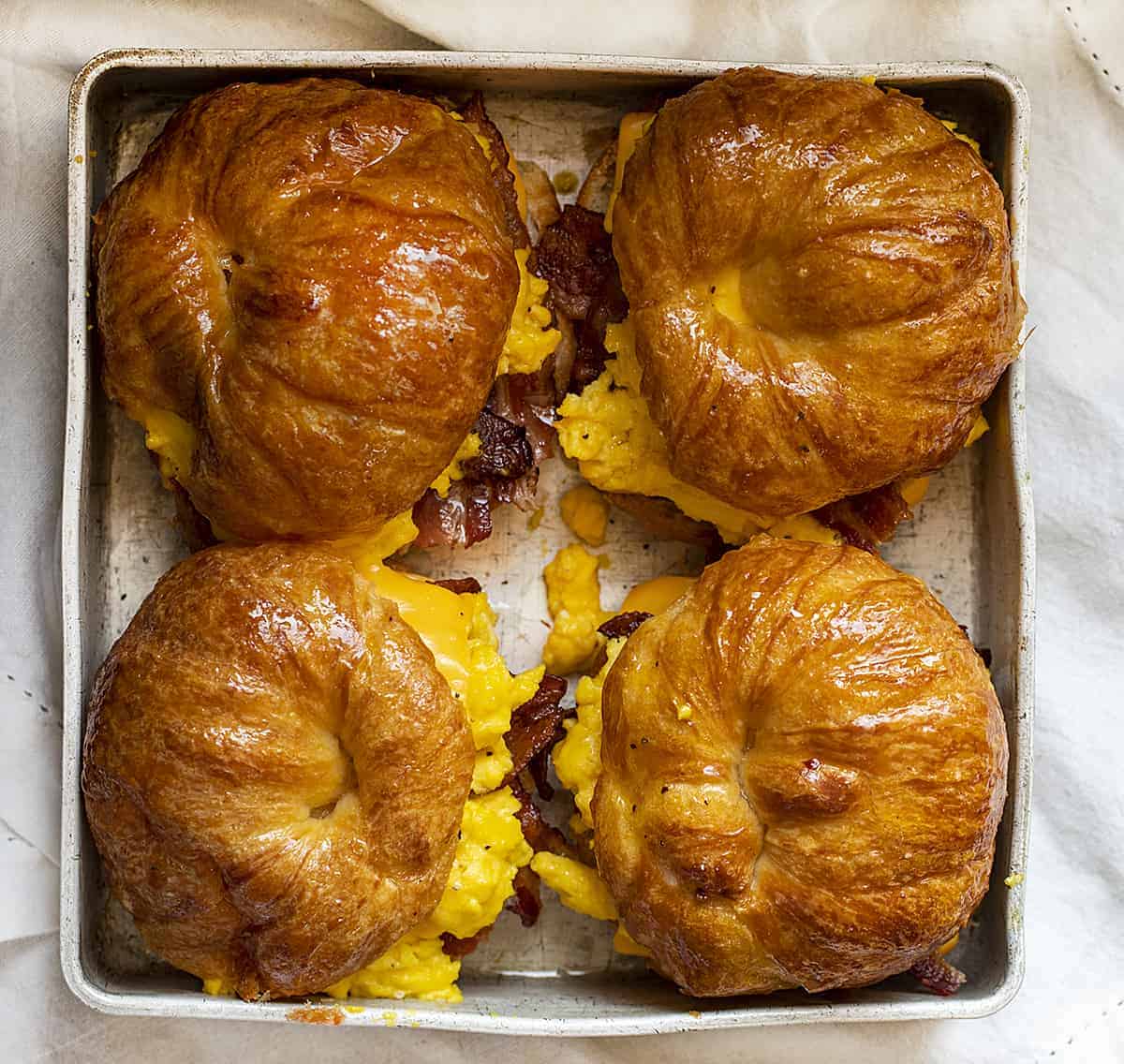 Overhead Image of Bacon Egg and Cheese Croissant Sandwiches in A pan